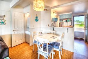 a kitchen and dining room with a table and chairs at Waters Edge Condo in Ocean Shores