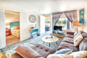 a living room with a couch and a table at Waters Edge Condo in Ocean Shores