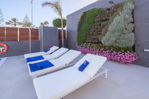 
a white table topped with blue and white pillows at Silvi Villas by TAM Resorts in Playa del Ingles
