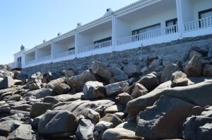 a large pile of rocks in front of a building at The Cormorant House in Lüderitz