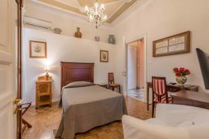 Posteľ alebo postele v izbe v ubytovaní Palazzo Benso