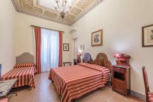Posteľ alebo postele v izbe v ubytovaní Palazzo Benso