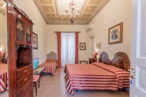 Posteľ alebo postele v izbe v ubytovaní Palazzo Benso