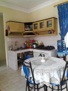 a kitchen with a table and chairs in a room at Villa Kota Bunga NA2 in Puncak