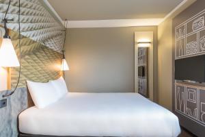 Cama ou camas em um quarto em ibis Genève Aéroport
