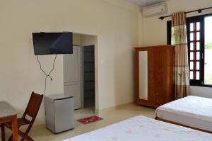 Postel nebo postele na pokoji v ubytování Ngoc Sang Guesthouse