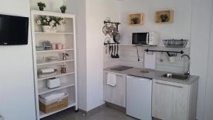 a kitchen with a sink and a counter top at Avenue Study in El Médano