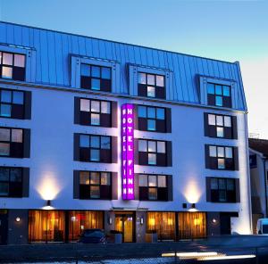 a building with a lit up sign on it at Finn Apartments in Lund