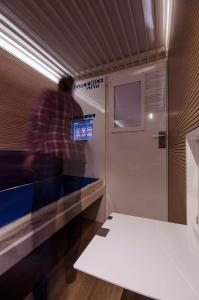 a man is in a subway train at Resting Pods - ZZZleepandGo BGY Airport in Orio al Serio
