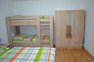 a bedroom with two bunk beds and a mirror at Apartmán Pohoda Nová Pec in Nová Pec