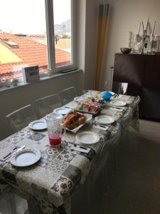 a table with plates and food on top of it at Casa Maria in Salerno