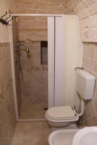 a bathroom with a shower with a toilet and a sink at il trullo di giada e mattia in Alberobello