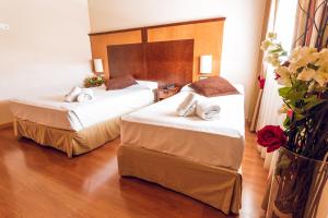 Postel nebo postele na pokoji v ubytování Hotel Bardo Recoletos Coco