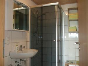 a bathroom with a sink and a shower at Ferienwohnung Bockelt in Stadtlauringen +23 photos