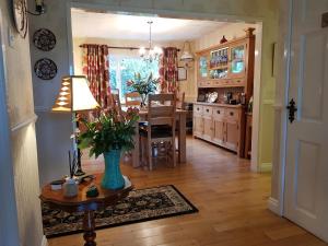 a kitchen and dining room with a table and a vase at Meadow View B&B in Ballymena