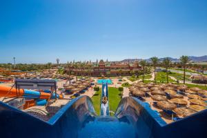 a blue and yellow pool filled with water next to a building at Aqua Blu Sharm El Sheikh - By Pickalbatros in Sharm El Sheikh