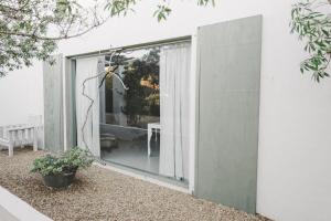 a sliding glass door on the side of a house at Gelukkie in Paternoster