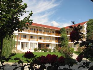 an exterior view of a building with red roof at Hostel White Inn in Costinesti