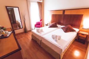Postel nebo postele na pokoji v ubytování Hotel Bardo Recoletos Coco