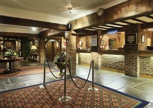 a lobby with a room with a fireplace and a table at Copthorne Hotel London Gatwick in Crawley