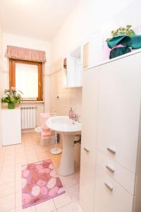 a bathroom with a sink and a white cabinet at Moi Moi B&B in LʼAquila