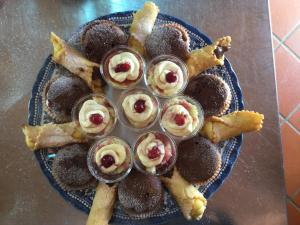 a plate of food with desserts on a table at La Fonte in Sala Consilina +11 photos