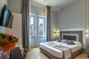 a bedroom with a bed and a television in it at Pantheon Caesar Relais in Rome +34 photos