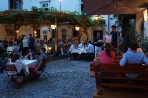 a group of people sitting at tables in a restaurant at Minihotel Graz in Graz