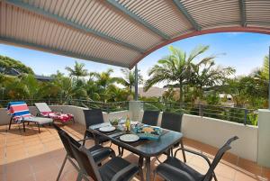 a patio with a table and chairs on a balcony at Byron Bay Accom Unit 8 22 Paterson Street, Byron Bay - Solaris in Byron Bay