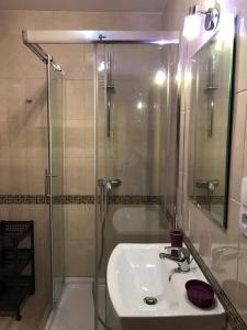 a bathroom with a shower and a sink and a glass shower stall at Dom gościnny Jarek in Rowy +36 photos