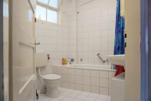 a bathroom with a toilet and a tub and a sink at Ferienwohnung Bauknecht in Pforzheim +31 photos