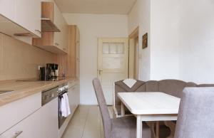 a small kitchen with a table and chairs in a room at Ferienwohnung Bauknecht in Pforzheim