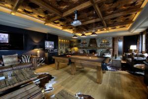 a living room filled with furniture and a large window at El Lodge, Ski & Spa in Sierra Nevada