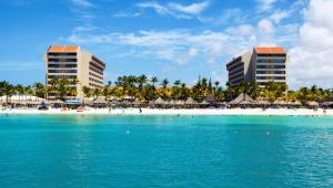 a view of a beach with buildings in the background at Barceló Aruba - All Inclusive in Palm-Eagle Beach