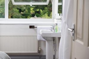 a bathroom with a sink and a window at Skiddaw Croft Bed & Breakfast in Keswick +34 photos