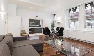 a living room with a couch and a table at Fleet Street Apartment 1 in London