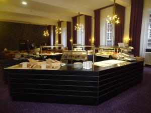 a restaurant with a buffet line in a room at Abdij Hotel Rolduc in Kerkrade