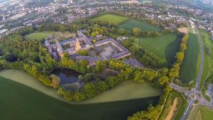 an aerial view of a mansion on a lake at Abdij Hotel Rolduc in Kerkrade