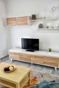 A television and/or entertainment centre at WonderStays Apartamentos Maribel