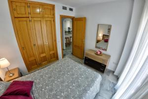 A bed or beds in a room at WonderStays Apartamentos Maribel