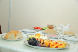 a table with many plates of food on it at Muzaffar Hotel Samarkand in Samarkand
