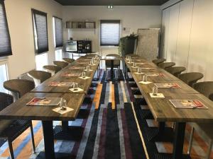 a row of tables in a room with chairs at Kyriad Direct Agen in Castelculier