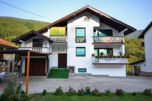 a white house with a sign on it at VIP Rooms Foča, Accommodation Foca, Foca Rooms in Foča
