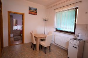 a small kitchen with a table and chairs and a window at VIP Rooms Foča, Accommodation Foca, Foca Rooms in Foča