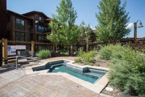 a swimming pool in the yard of a house at Silver Baron Lodge in Park City