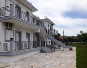 a white building with stairs on the side of it at Paleo Kalamaki in Isthmia