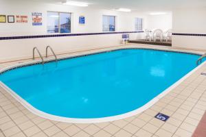 una piscina en una habitación de hospital con agua azul en Super 8 by Wyndham Monmouth IL, en Monmouth