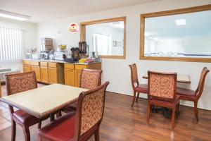 a kitchen and dining room with a table and chairs at Super 8 by Wyndham Monmouth IL in Monmouth