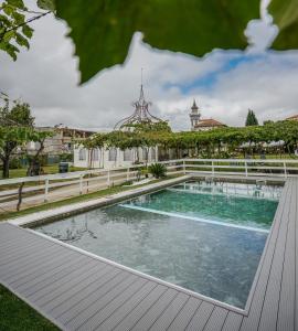 a swimming pool in the yard of a house at Palacete Villa Idalina in Caminha