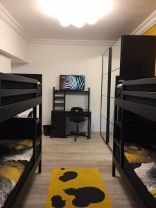 a room with two bunk beds and a desk at Luxury Mohandeseen Apartment in Cairo